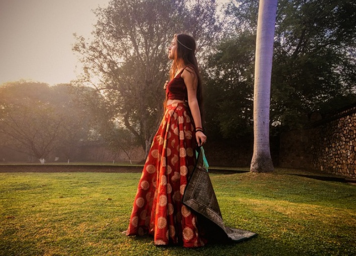 A Young Woman in a Long Skirt Looking over her Shoulder · Free Stock Photo